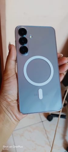 Customer holding their phone in the Anti Yellow Magsafe Clear Case, showing the white magnetic ring on the back.