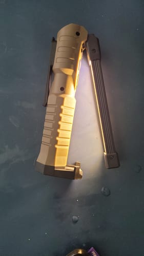 Customer's tan 180º Work Light illuminated, attached to a dark surface with its magnetic base.