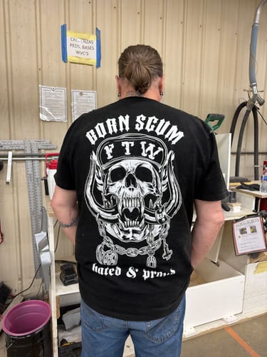 Reviewer at work, shown from behind wearing the black HATED & PROUD T-SHIRT with its detailed skull graphic.