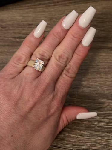 Reviewer's hand wearing the GlowStone Collection silicone ring with a large, emerald-cut cubic zirconia.