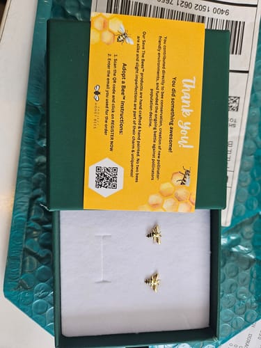 Customer's Luxury Queen Bee Earrings Gold resting in their green presentation box.