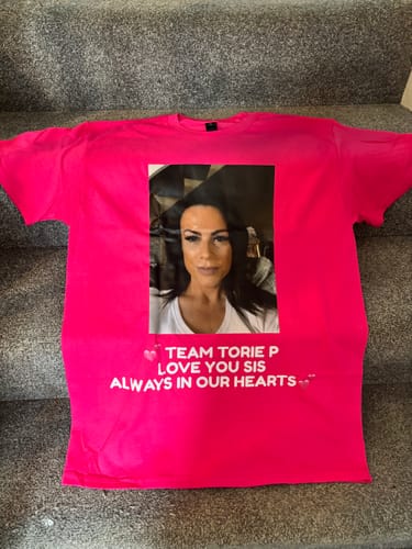 Customer's pink unisex t-shirt with a custom photo and memorial text printed on the front.