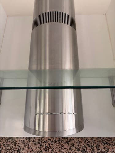 Customer's stainless steel range hood partially cleaned with SHYN products, showing a contrast between the dull top and shiny bottom.
