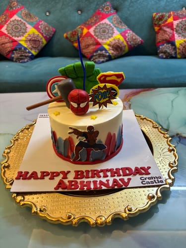 Customer's Spiderman Cityscape Cake with colorful superhero themed decorations on a gold platter.