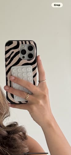 Customer holding their phone in a mirror, showing the back of the cute zebra tough iPhone case.