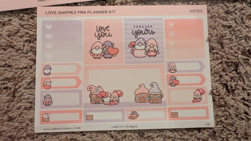 Customer's sticker sheet from the Lovely Gnomes Mini Planner Kit, with cute pink and purple love-themed gnome stickers.