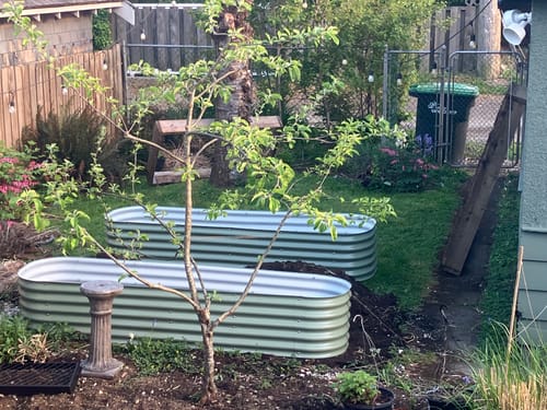 Customer's two 17” Tall Modular garden boxes assembled and placed in a grassy backyard.
