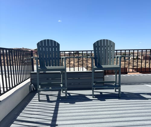 Customer's grey Counter Height Bistro Tete-a-tete set on a spacious rooftop deck.