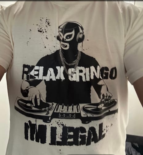 Customer wearing the white Relax Gringo I'm Legal Luchador T-Shirt showing the graphic.