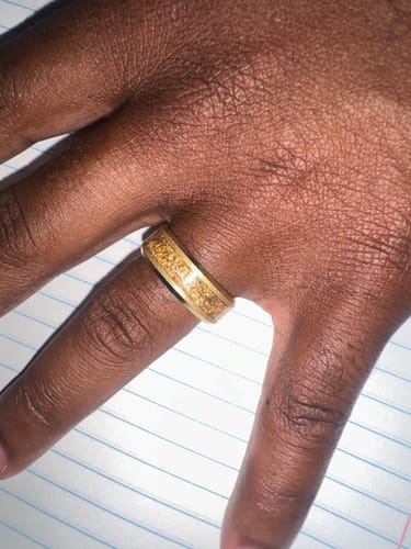 Customer wearing the wide Aureum ring, showing the textured gold foil inlay on their finger.