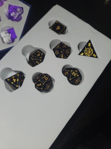 Reviewer's Blue Sandstone Dice Set with gold numbering displayed in its white foam packaging.