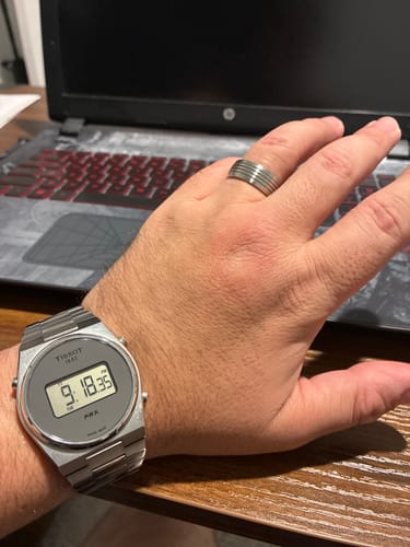 Customer wearing the silver 8mm Four Lined Band on their hand.