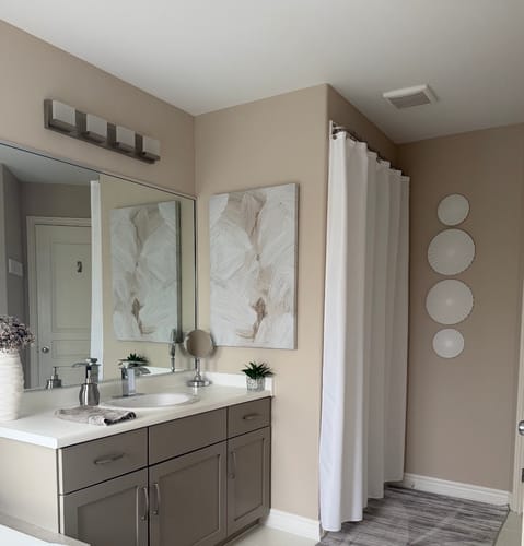Customer's Neutral Brush Canvas Wall Art hanging on a beige wall in a modern bathroom.