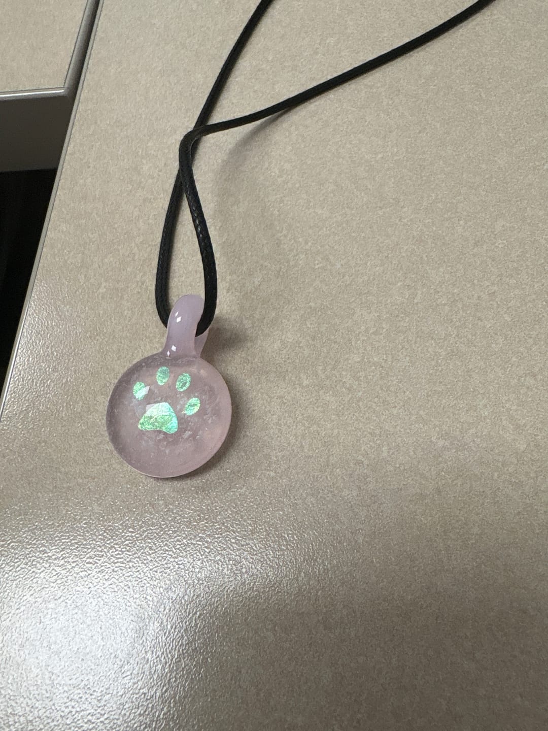 Customer photo review of Pawprint Foil Pendant with Cremation Ash