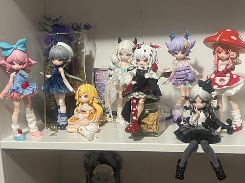 Customer's eight unique Mogo Bloom action figures in detailed outfits posed together on a shelf.