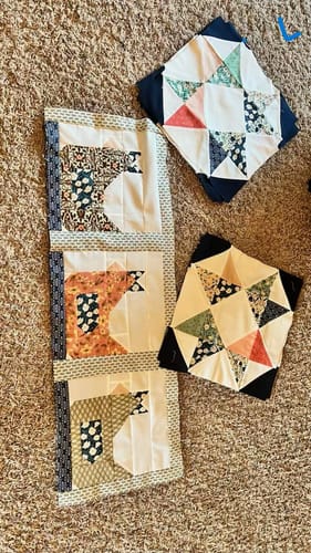 Customer's progress on the Cluckin' Crazy Block-of-the-Month Kit, showing completed chicken and star blocks laid out.