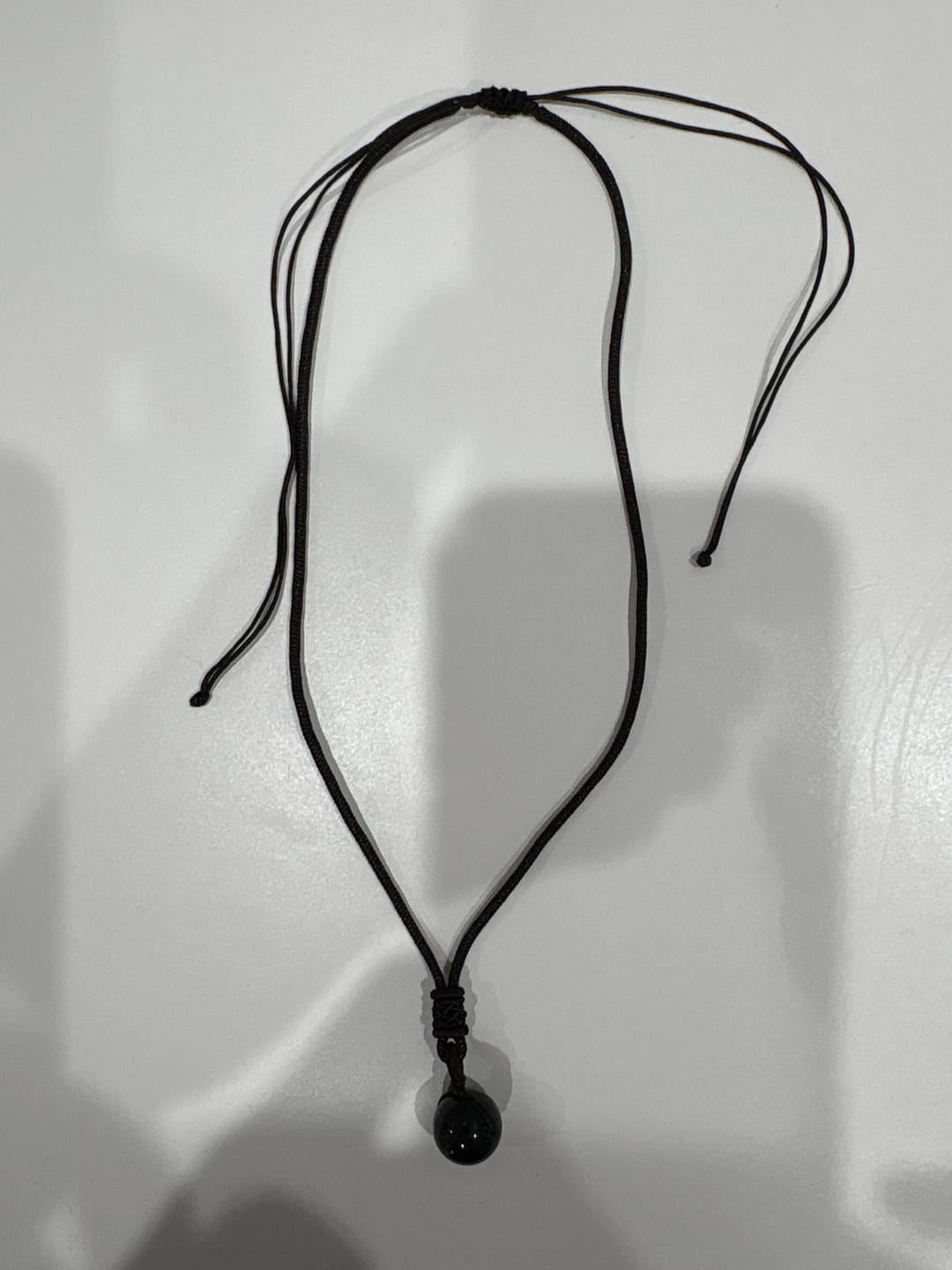 Customer photo review of Pendentif "Sphère" en Obsidienne Dorée