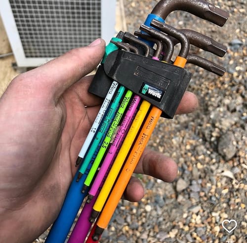Customer holding the colorful, well-used Wera Hex-Plus Multicolour L-key set in hand.