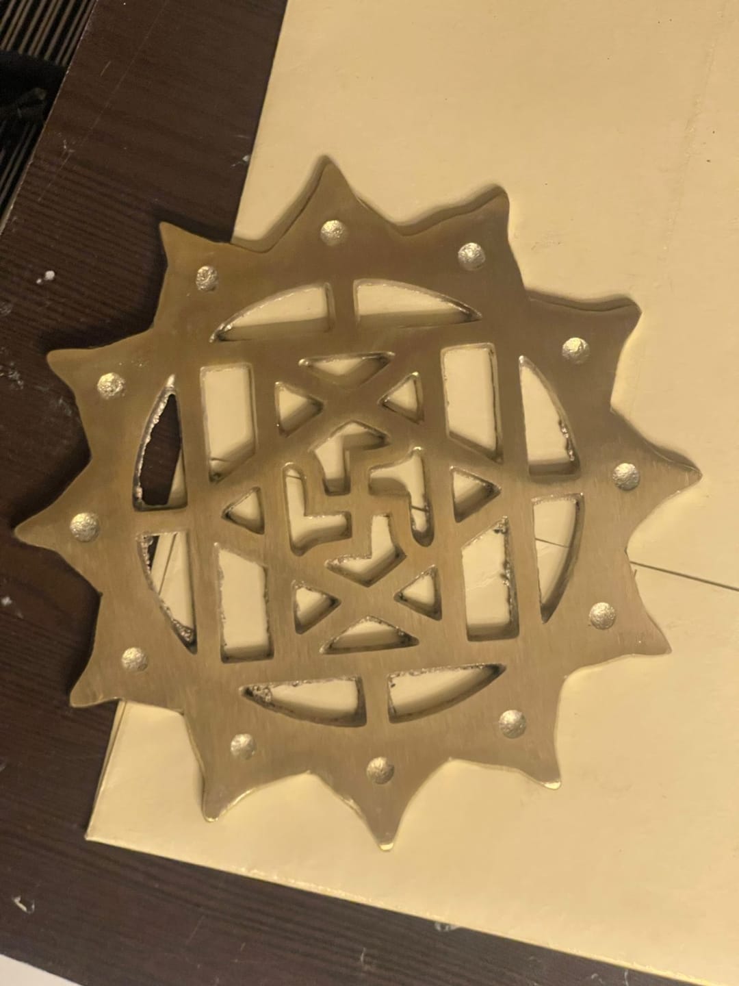 Customer photo review of Brass Swastik with Lotus Helix – Vastu Remedy for Main Door Protection | Evil Eye & Positive Energy Shield | Kitchen/Entrance Placement | 6 x 6 Inch