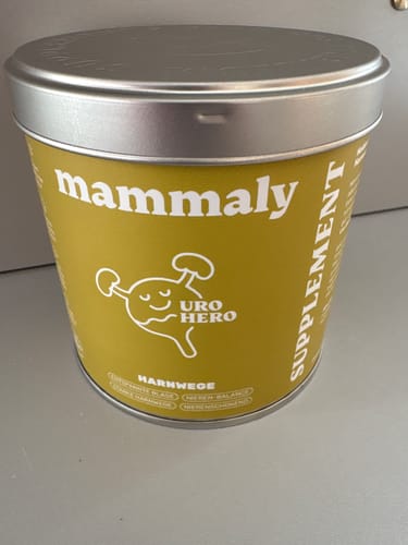 Foto eines Kunden von der senfgelben Dose des Uro Hero-Supplements mit silbernem Deckel.