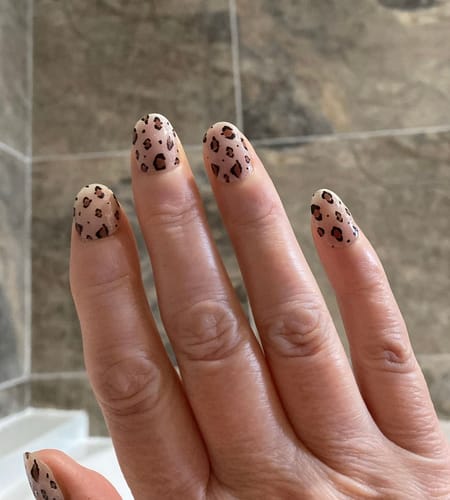 Customer's hand showing their rounded nails with the Cheetah Holy Gels applied.