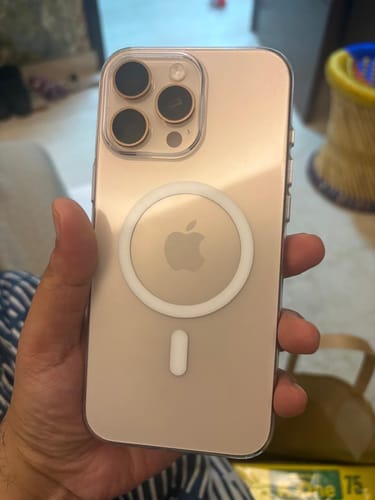 Customer holding their iPhone in the clear Anti Yellow Magsafe Case, showing the back of the phone and the white MagSafe ring.
