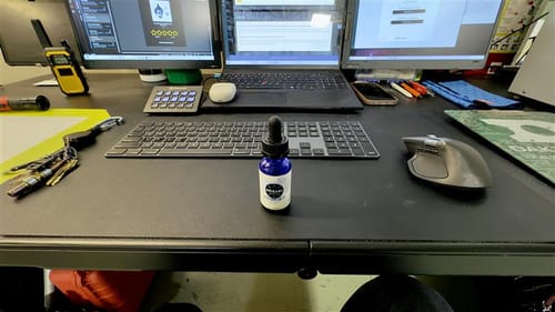 Customer's Meraki Blu Methylene Blue dropper bottle sitting on a computer desk.