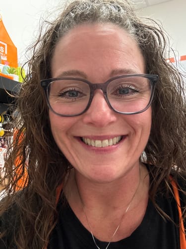 Reviewer with glasses smiles, showing defined lashes from My Amazing Lashes Mascara.