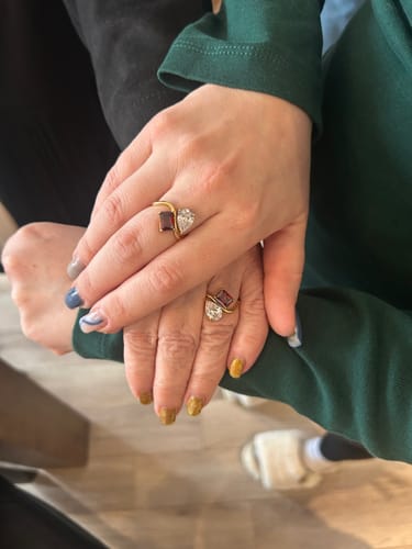 Customer shows matching Navae Birthstone Rings on two hands, one layered over the other.