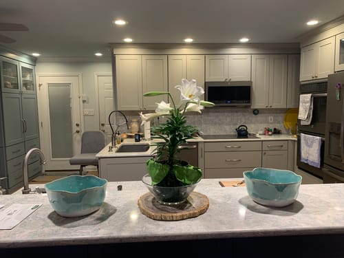 Customer's two aqua blue Organic Deep Bowls displayed on a kitchen island for decoration.