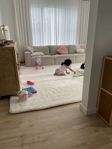 Reviewer's child playing on the large Vanilla Cream Mellow Mat in their living room, matching the neutral decor.