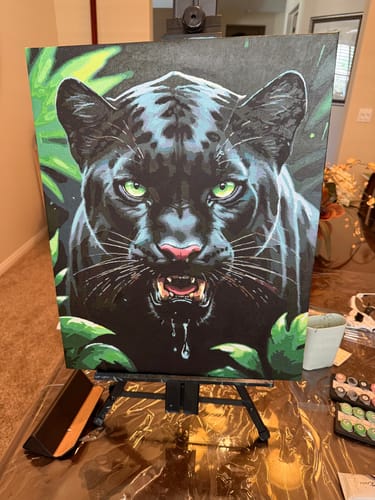 Customer's completed Black Panther in Jungle paint by numbers kit. The detailed painting shows a growling panther on an easel.