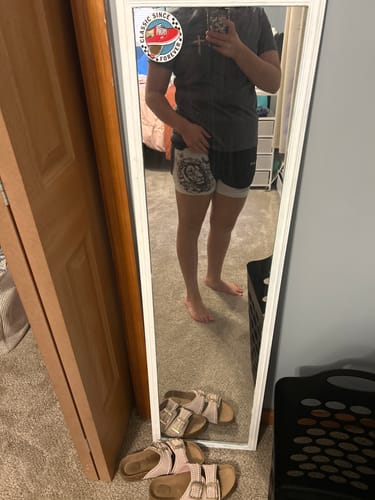 Customer shows the fit of the 'Courageous Roar' Women's Performance Shorts in a mirror selfie.