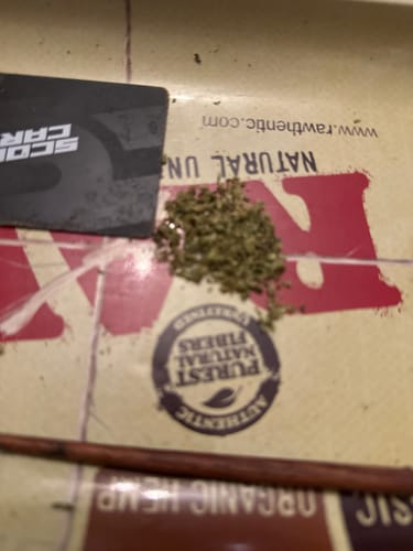 Close-up of the ground-up flower from the customer's Cherry Dosi Do Pre-Rolls on a rolling tray.
