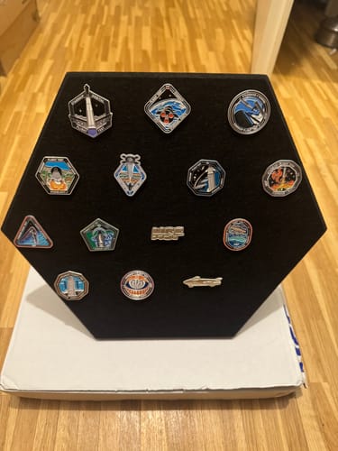 Customer's SpaceX Starship Flight Pin Collection arranged on the black, hexagonal felt display mount.