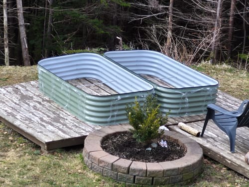 Customer's two assembled 17” Tall Modular garden beds sitting empty on a wooden deck.