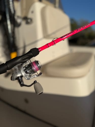 Customer's pink Waterloo Pink Tide Series rod with a reel attached, shown on a boat.