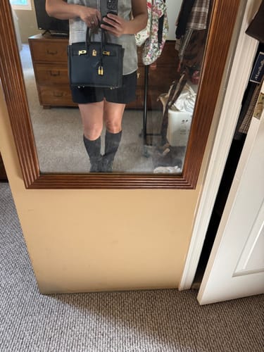 Reviewer holding their black structured LALUVA Warkin Bag with gold hardware in a mirror selfie.