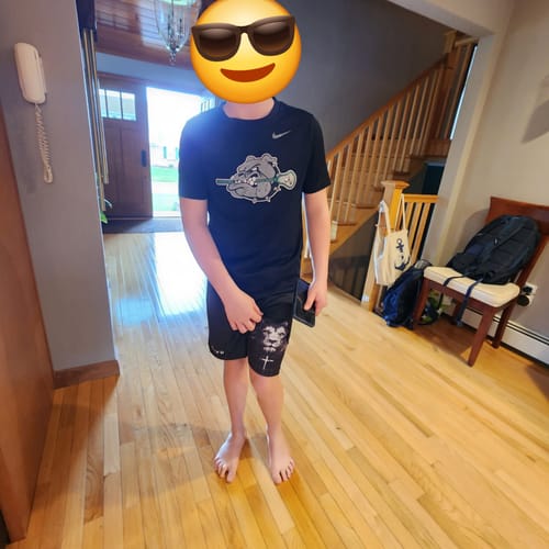 Customer photo submitted with a review for the black Training Tee, showing the reviewer's son.