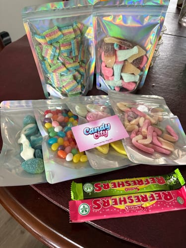 Customer's Giant Fizzy Bubblegum Bottles in a holographic bag, shown with other assorted candies.