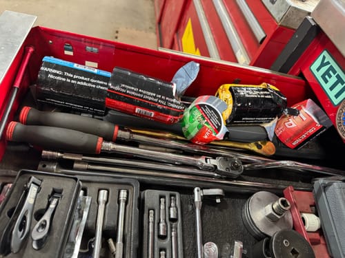 Customer's various Sweet Nectar Nicotine Pouches inside a red toolbox drawer filled with tools.