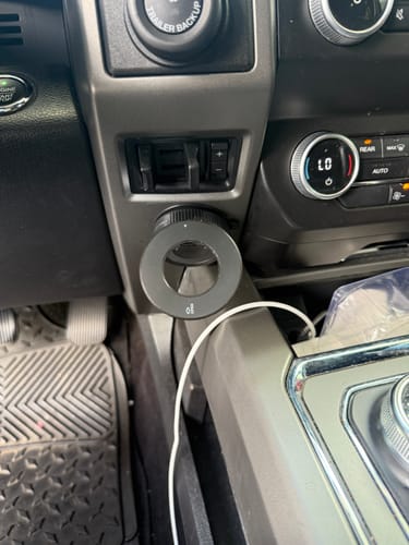 Reviewer's MagMount Pro phone mount attached to the center console of their car.