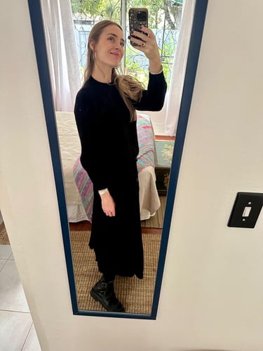 Reviewer taking a mirror selfie, wearing their black Tankwa boots with a long black dress.