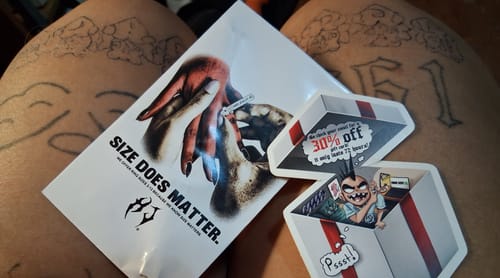 Reviewer showing the packaging for the FREE RING SIZER and promotional stickers received with the order.