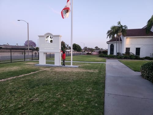 Reviewer at their building with the flagpole for their new American flag.