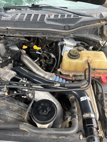 Customer's engine bay with the SPE Motorsport CCV Reroute Kit installed, showing black and silver components.