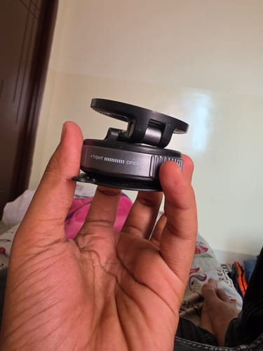 Customer's hand holding the black and silver 360° MagPro Magnetic Phone Holder, showing the adjustment ring.