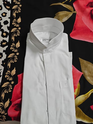 Customer's folded white shirt from the Double Delight combo, showing the clean material and band collar.