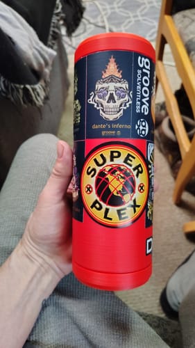Customer holding a red Double Tactical Reload Can Holder that they have covered in colorful stickers.