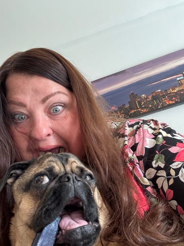 Reviewer and their happy pug playfully chewing on a blue Long-Lasting Yak Chew.